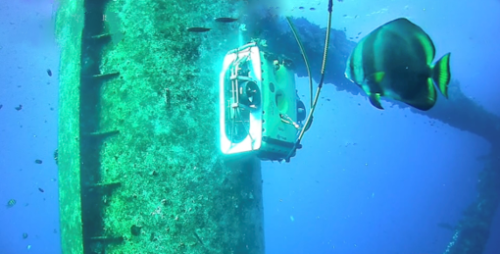 ROV inspecting growth of coral on a structure.
